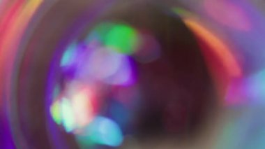 Kaleydoskop gecesinin dikkati dağıldı. Dairesel ışıltı. Gökkuşağı renkleri parlak kürede parıldıyor. Neon lens soyut mor kırmızı yeşil bulanık arkaplan.