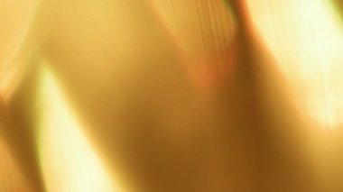 Görüntü pırıltısı. Soyut ışık. Ilık turuncu renk ışıl ışıl parıldıyor. Görsel ışıl ışıl, göz kamaştırıcı sanat arkaplanı..