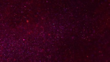 Bulanık daireler. Parıldayan ışık. Soyut parlak siyah bokeh arkaplan üzerinde odaksız kırmızı renkli optik parlak parlak parlak yuvarlak dokuma.