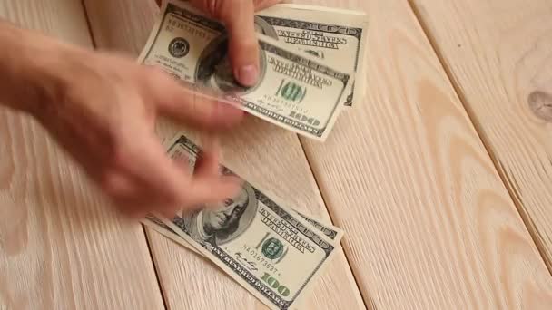 Human hands count money on a wooden background — Stock Video