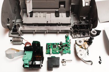 parts of the broken ink jet printer on white background