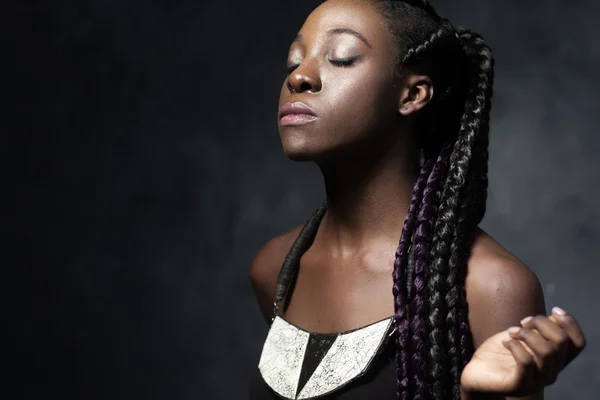 Beautiful Black woman with long hair smells — Stok fotoğraf