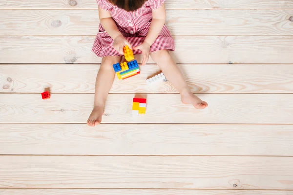 Dziewczynka na drewnianej podłodze gry Lego — Zdjęcie stockowe