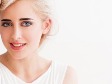 confident blonde in white smiles