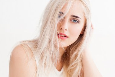 disheveled blonde calmly and trustingly looks 