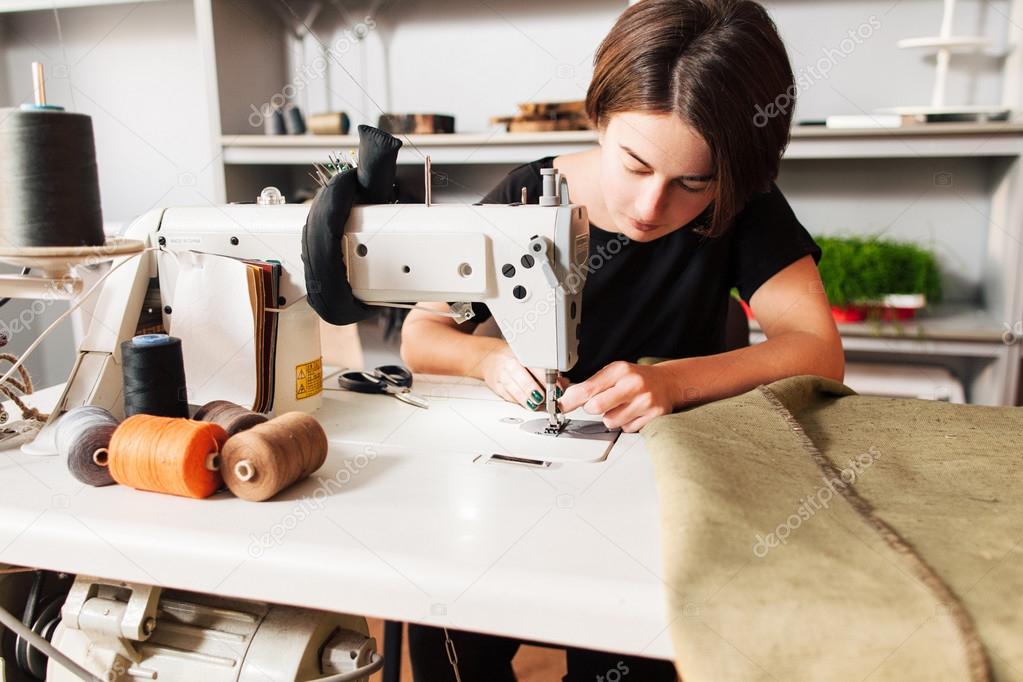 seamstress  put thread in needle. tailor's workplace