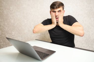 bilgisayar başında çalışan şaşırmış kişi