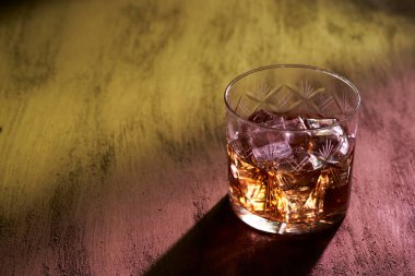 Barda renkli ışıkları olan bir bardak viski.