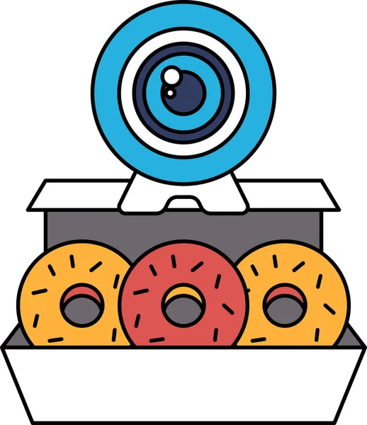 Üzerinde web kamerası olan bir kutu donut masanın üzerinde duruyor. Web kamerası siyah ve beyaz, çörekler yuvarlak ve şeker serpiştirilmiş. Hoşgörü ve rahatlama kavramı