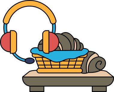 Yemek dolu bir sepet bir çift kulaklığın yanındaki masaya yerleştirilir. Kulaklıklar masanın üzerinde.