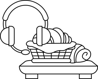 Yemek dolu bir sepet bir çift kulaklığın yanındaki masaya yerleştirilir. Kulaklıklar masanın üzerinde.