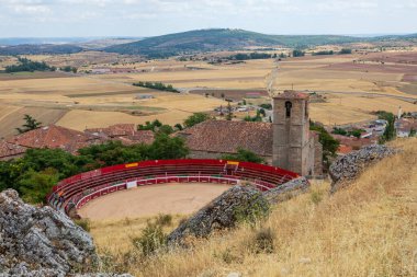 İspanya 'nın Guadalajara kentindeki Atienza şehrinde kurak tarlalar ve kayan tepelerle dolu bir arena bulunmaktadır. Köy, geleneksel İspanyol kültürüne bir bakış sunuyor..