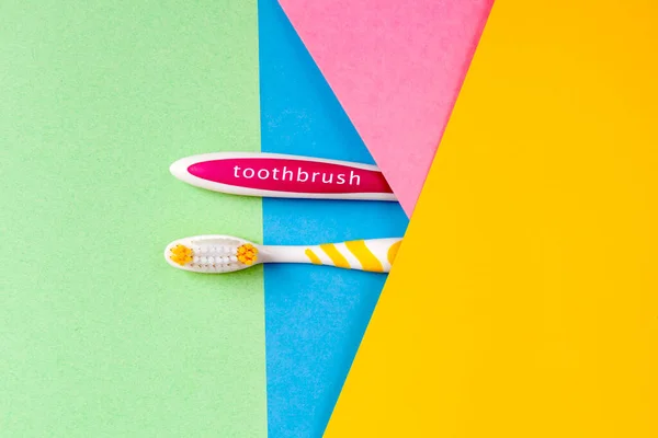 Toothbrushes Two Colors Yellow Pink Multi Colored Background Horizontal Copy — Stock Photo, Image