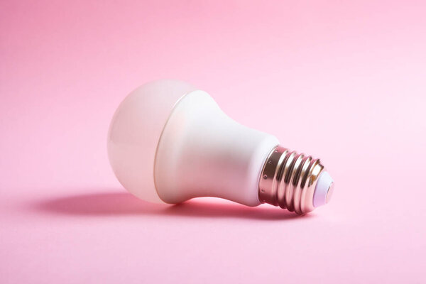 lit light bulb isolated on a pink background. Idea concept.