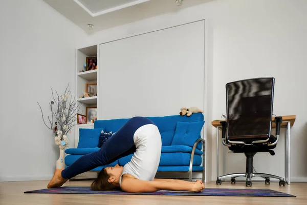 Mujer Joven Practicando Yoga Casa Haciendo Pose Arado —  Fotos de Stock