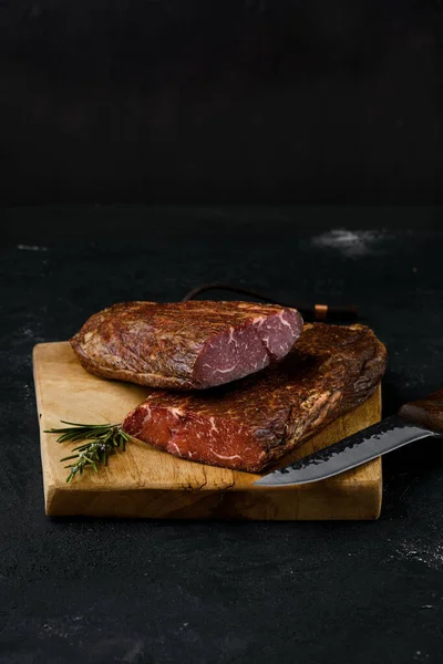Smoked beef striploin meat on cutting board