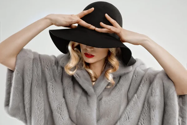 Attraktive blonde Dame in grauem Pelzmantel und schwarzem Hut — Stockfoto