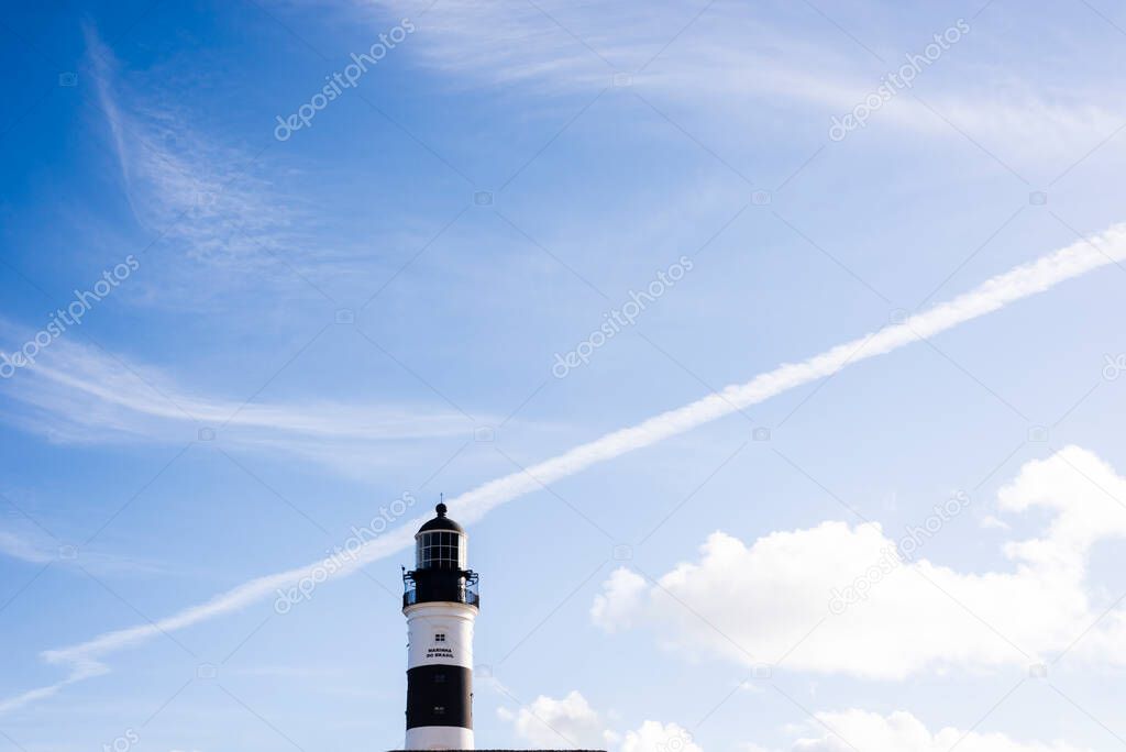 Salvador, Bahia, Brazil - August 08, 2021: Bright blue sky over the famous Farol da Barra. Many visited by tourists from all over the world. A real postcard of the city.