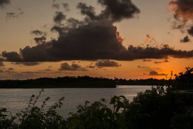 Camacari, Bahia, Brezilya - 17 Ekim 2015: Camacari, Bahia 'da dramatik bulutlarla güzel turuncu ve sarı gün batımı,