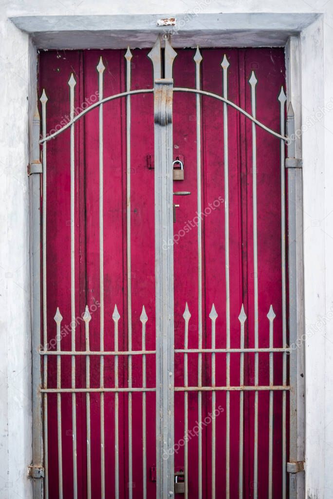 Antique door details in color with shadow, iron, cement, wood.Pelourinho, Salvador, Bahia, Brazil.