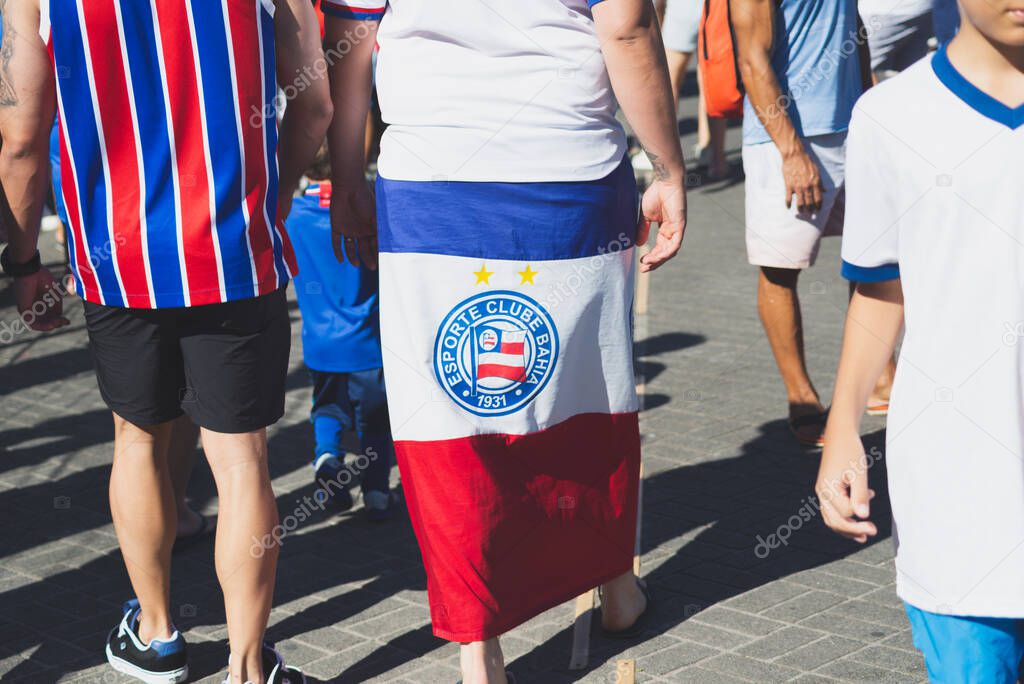 Salvador, Bahia, Brazil - November 2, 2025: A fan of Esporte Clube Bahia is seen with a flag wrapped around his body before the game against Bragantino. Salvador, Brazil.