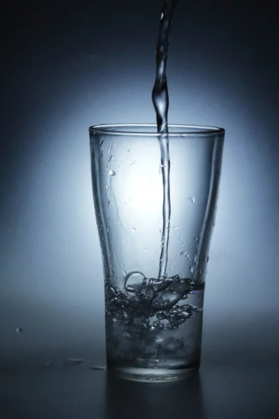 Pouring water into glass — Stock Photo, Image