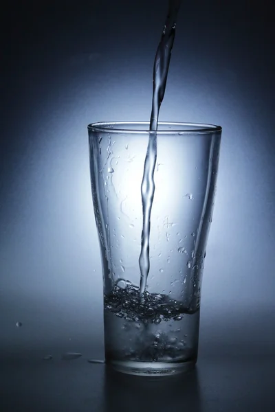 Pouring water into glass — Stock Photo, Image