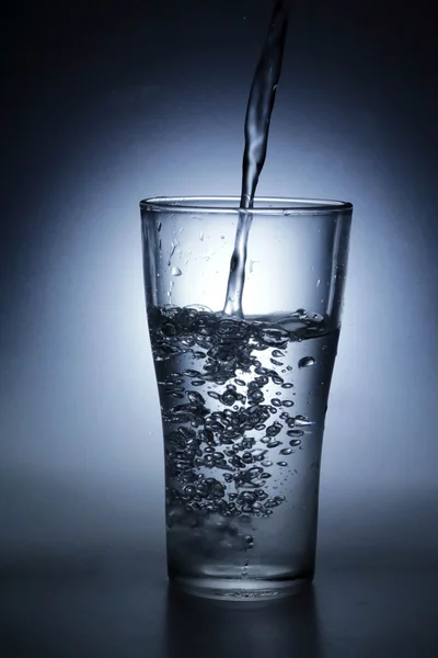 Pouring water into glass — Stock Photo, Image