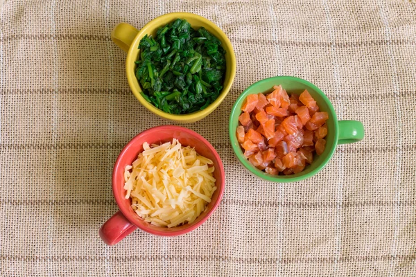 Triangle of ingredients in colorful cups — Stock Photo, Image