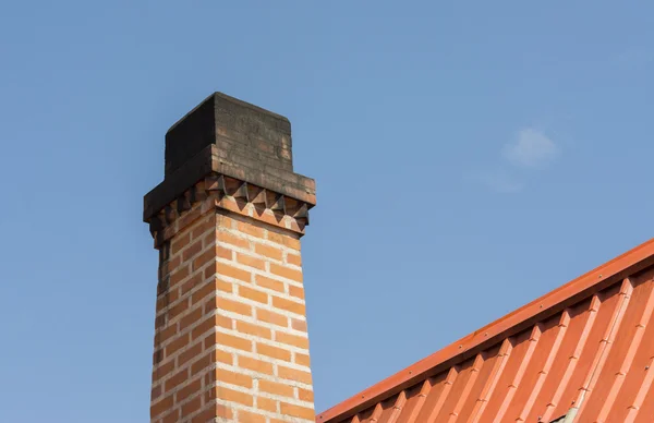 Chimney with roof tiles, Orange on blue sky background — Stock Photo, Image