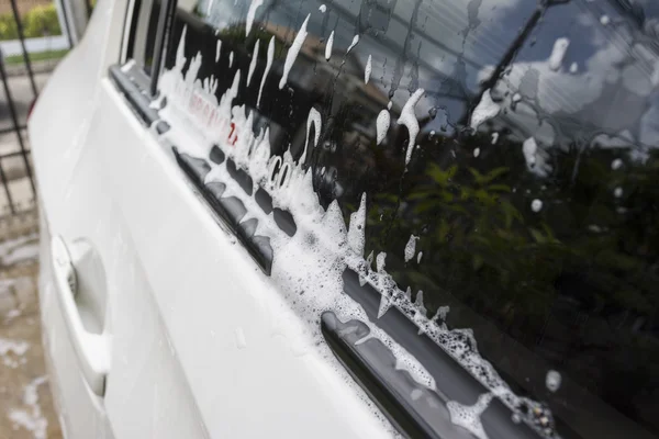 Soap bubbles on car window before car wash — Stock Photo, Image