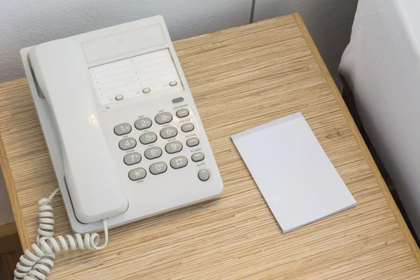 Il telefono sul tavolo con un taccuino di carta e una matita. Nel — Foto Stock