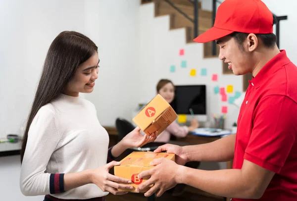 Women are choosing and receiving parcel boxes from the courier staf. Courier Staff delivers a parcel to a woman who orders from online at a home office. in transportation and delivery concept