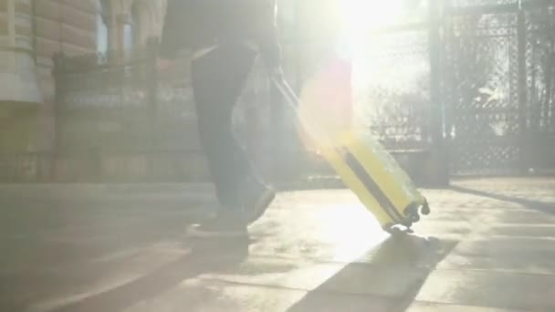Man Walks Street Carrying Yellow Tourist Suitcase Wheels Wet Street — Stockvideo