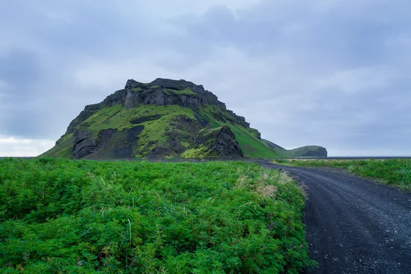 Iceland landscape with rock and long road — Stock Photo, Image