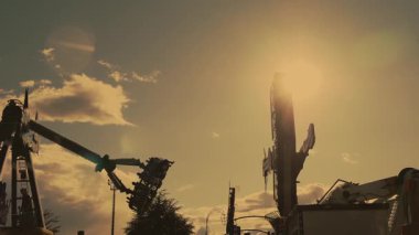 Dönen dev sarkacı altın günbatımında hareket halinde. Aktif eğlence ve eğlence için popüler eğlence parkı eğlencesi.