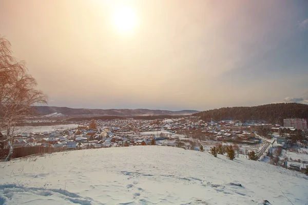 Russian Village in winter. Mountain view of a typical Russian village covered in snow.