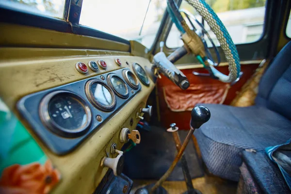 Interior vintage de un coche viejo con un tablero de instrumentos retro y volante en una cubierta de PVC — Foto de Stock