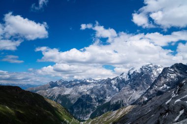 Alp yolu ve yamaçta karlı yaz Stelvio geçidi. Lombardy ve Trentino arasındaki Alplerin panoramik görüntüsü. Renkli görüntü. İtalyan dağları.