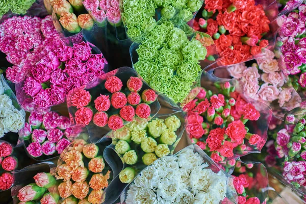Beautiful bouquets of mixed flowers in a flower shop. A bright mix of flowers. Background on full screen. Handsome fresh bouquets. Flowers delivery. Floral shop. Selective focus.
