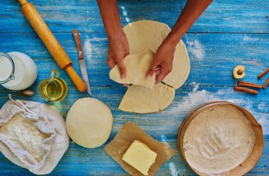 Housewife cuts the dough into pieces triangular form