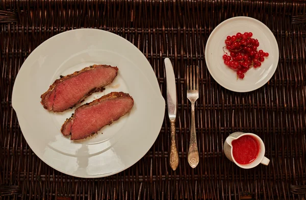 Two fried steak lie on a large white plate — Stock Photo, Image