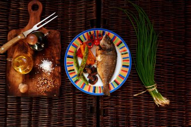 There is  Beautiful colorful fish on a plate