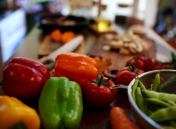 There are Fresh vegetables on a kitchen table