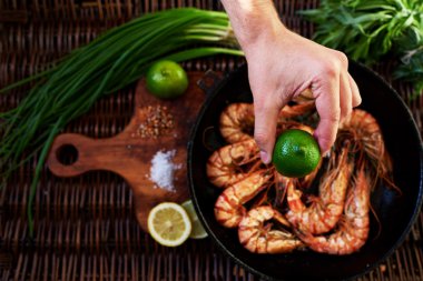 Girl chef squeezes out lime shrimp