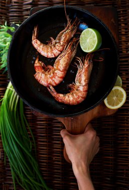 Girl chef squeezes out lime shrimp