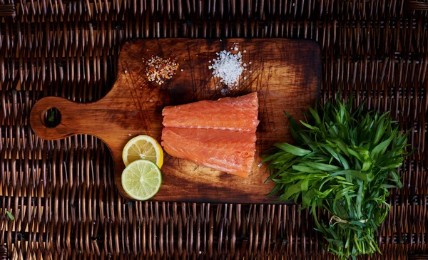 There is fresh piece of fish on a wooden board — ストック写真