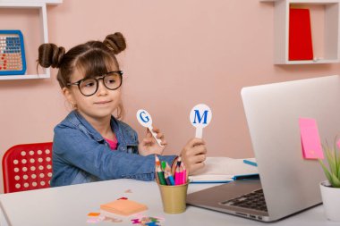 Online Preschool Classes. Excellent online learning for kids. Happy schoolgirl learning online.