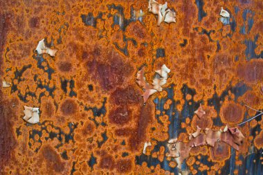 Büyük turuncu pas lekeleri mavi duvar arka plan dokusunu kaplıyor