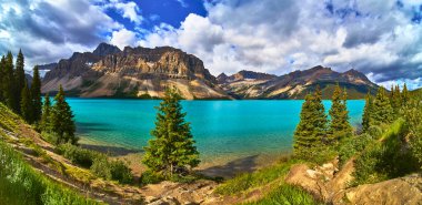 Bow Lakes canlı turkuaz su, dramatik dağ arkaplanı ve yemyeşil yemlikler Banff Canada 'da nefes kesici bir manzara yaratarak doğal güzelliğin ve açık hava macerasının özünü yakalıyor..